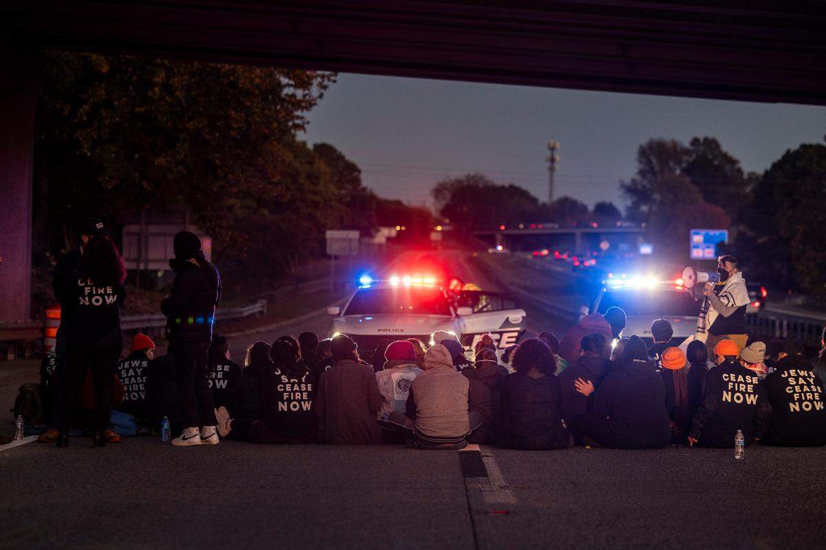 Protesters block the northbound lanes of the Durham Freeway at the South Magnum Street bridge for hours Thursday evening, Nov. 2, 2023 while demanding a ceasefire in the Israel-Gaza War as police warned of arrests.