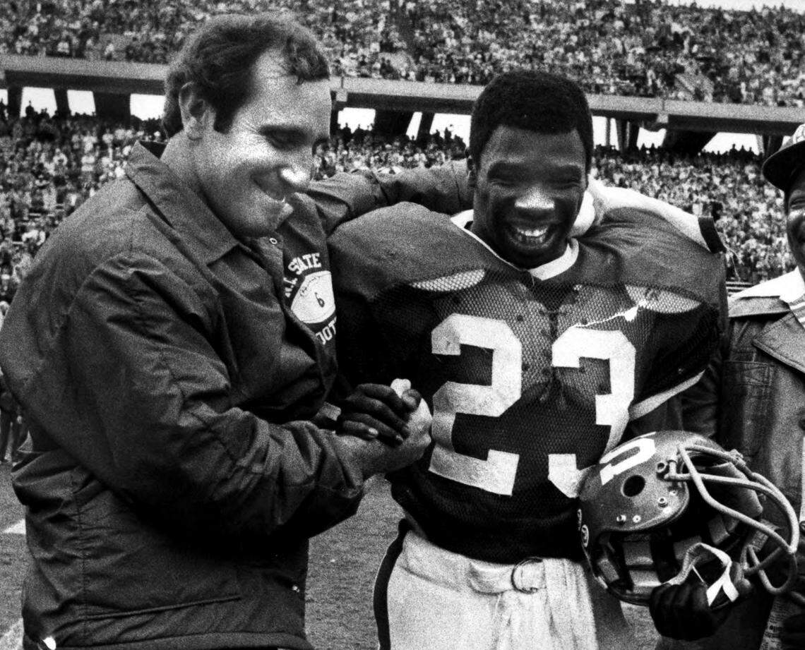 N. C. State football coach Bo Rein (left) congratulates running back Ted Brown on Ted Brown Day, held at Carter Stadium in 1978.