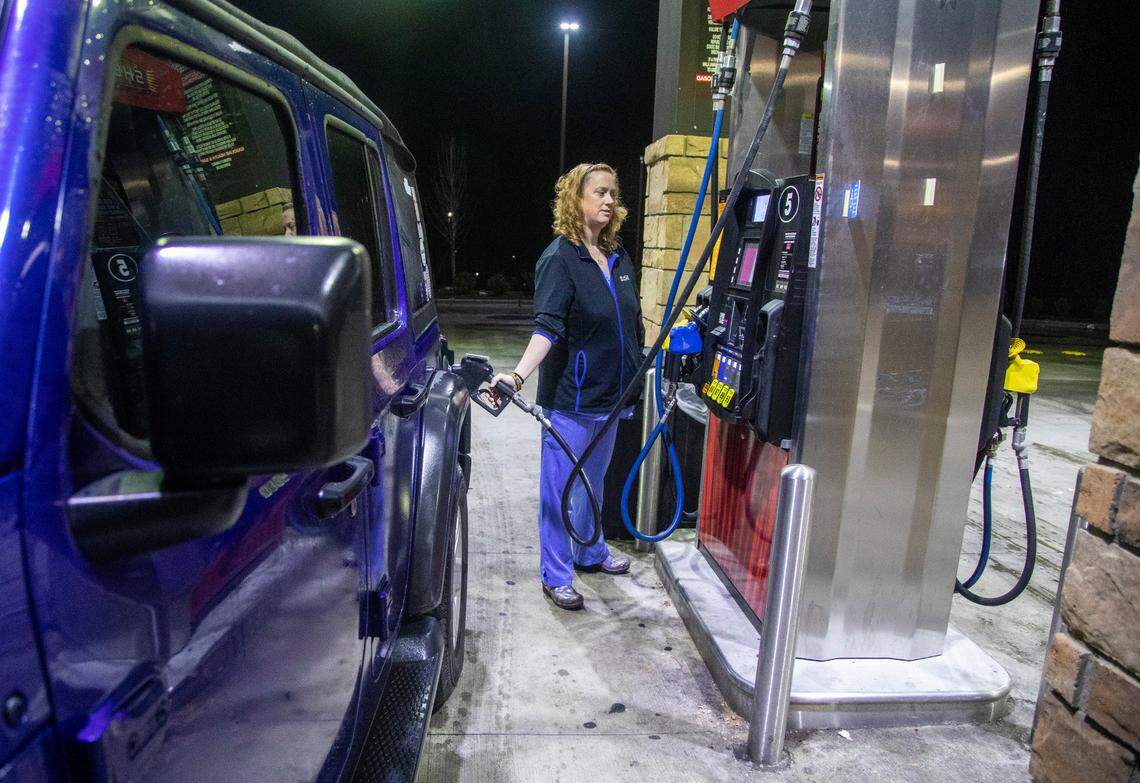 Julie Oram fuels her vehicle hours before sunrise at a Sheetz in Cameron Wednesday, Jan. 4, 2023. Oram, a 45 -year-old nurse with a husband who works at Amazon and two teenage boys moved from Garner to Fayetteville after a rent hike. She commutes more than 2 hours per workday.
