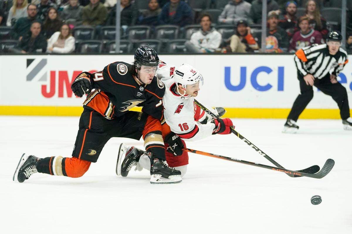 Anaheim Ducks defenseman Jamie Drysdale (34) defends against Carolina Hurricanes center Vincent Trocheck (16) during the first period of an NHL hockey game in Anaheim, Calif., Thursday, Nov. 18, 2021. (AP Photo/Ashley Landis)