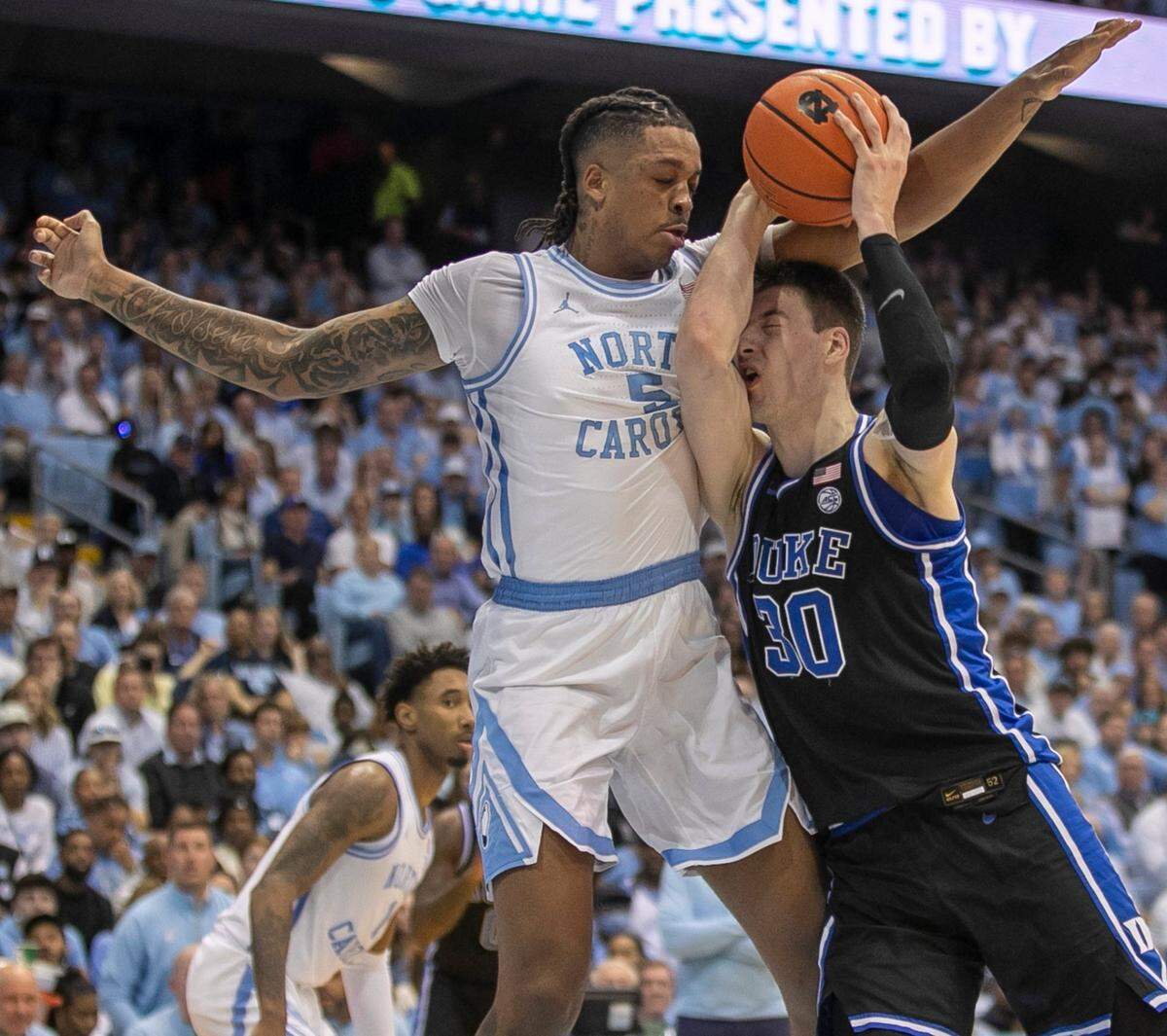 North Carolina’s Armando Bacot (5) defends Duke’s Kyle Filipowski (30) in the first half on Saturday, March 4, 2023 at the Smith Center in Chapel Hill, N.C.