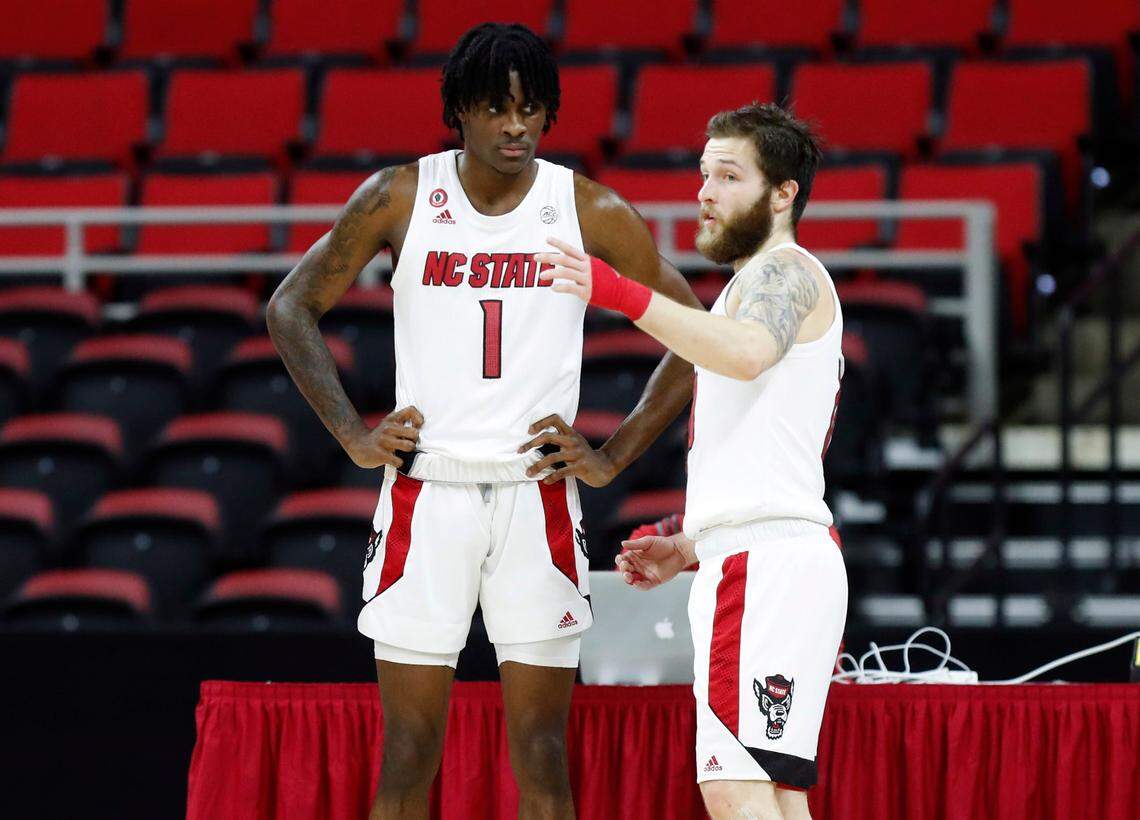 N.C. State’s Braxton Beverly (10) talks with Dereon Seabron (1) during the first half of N.C. State’s game against Campbell at PNC Arena in Raleigh, N.C., Saturday, Dec. 19, 2020.