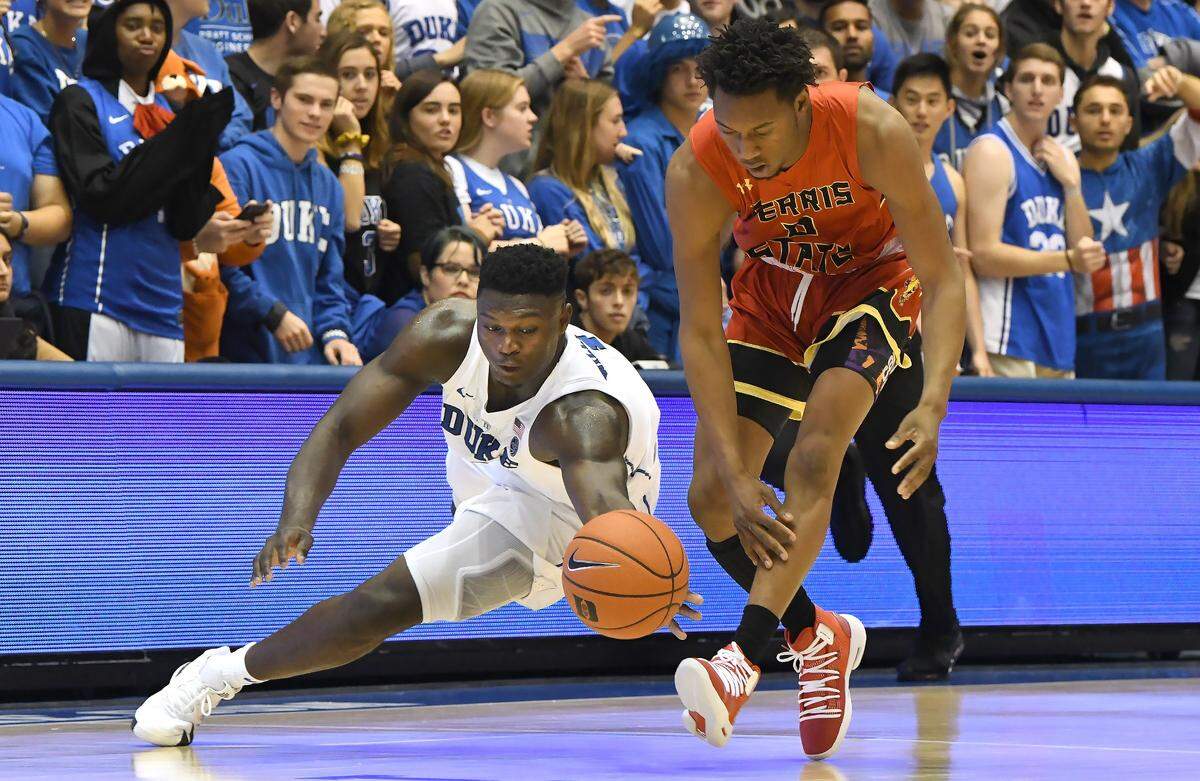 Duke’s Zion Williamson forward (1) dives for a loose ball in the second half against Ferris State’s Walt Kelser (0). Duke won their exhibition game against  Ferris State 132-48 at Cameron Indoor Stadium In Durham, N.C. Saturday, October 27, 2018.