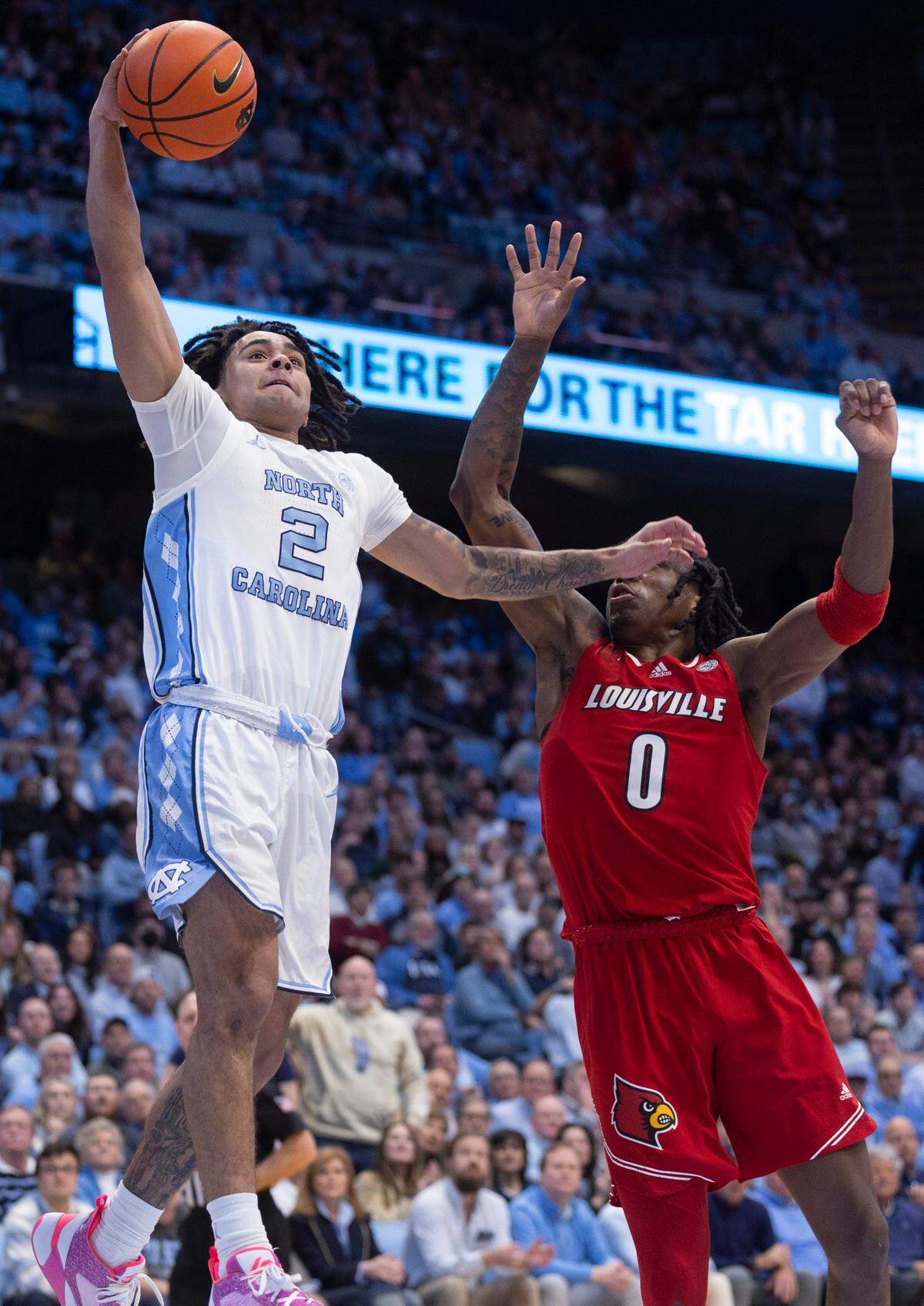 North Carolina’s Elliot Cadeau (2) breaks two the basket for a dunk on a fast break in the first half against Louisville’s Mike James (0) on Wednesday, January 17, 2024 at the Smith Center in Chapel Hill, N.C.