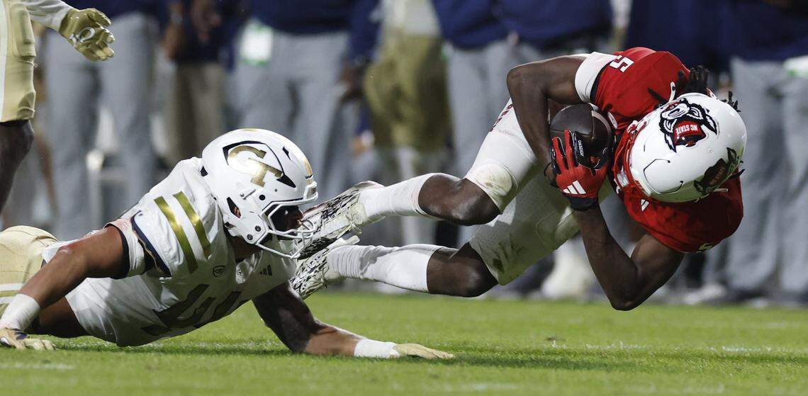 N.C. State wide receiver Noah Rogers (5) makes a long reception as Georgia Tech tight end Connor Roush (44) defends during the first half of N.C. State’s game against Georgia Tech at Carter-Finley Stadium in Raleigh, N.C., Saturday, Nov. 1, 2025.