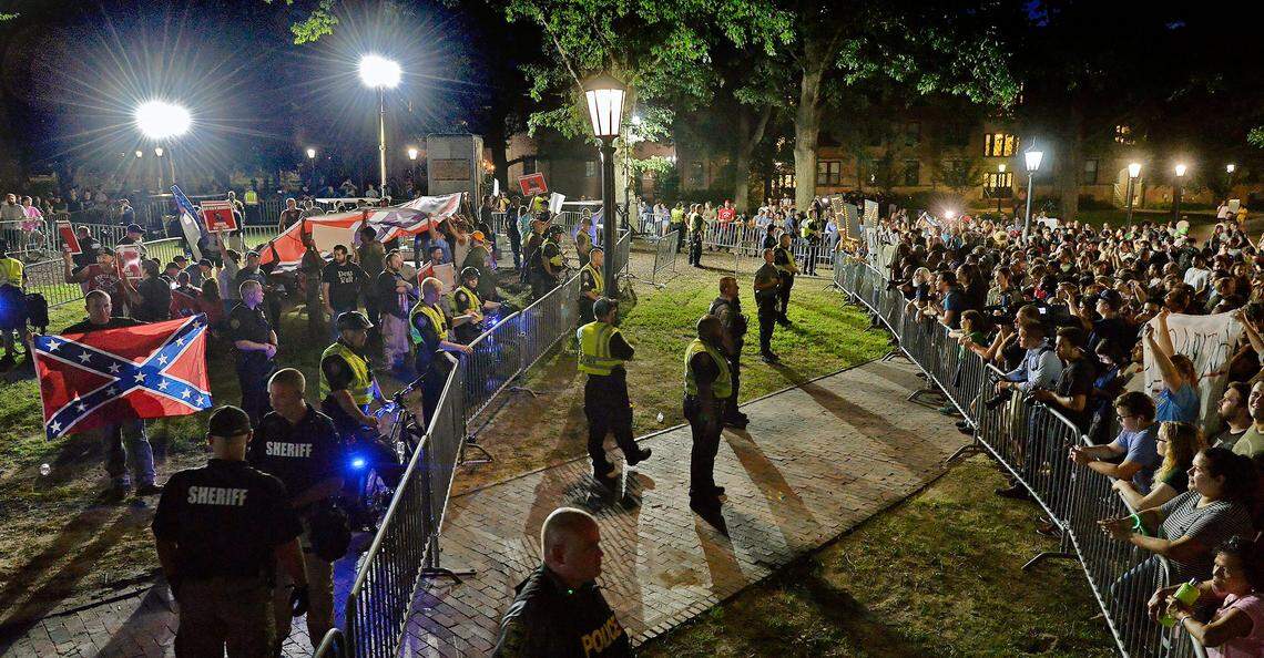 Members of ACTBAC and protesters face off at McCorkle Place on the campus of UNC-Chapel Hill, Thursday, August 30, 2018 during a rally to commemorate the Confederate statue known as Silent Sam by the Alamance County based group.