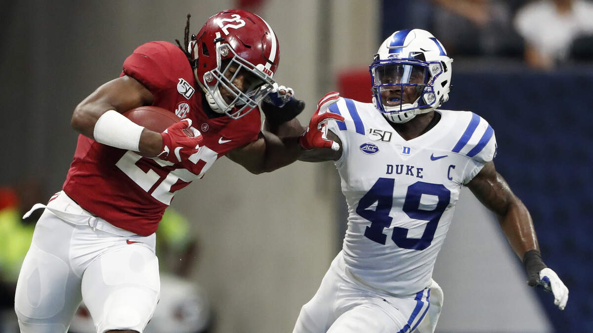 Alabama running back Najee Harris (22) tries to fend off Duke linebacker Koby Quansah (49) during the first half of an NCAA college football game, Saturday, Aug. 31, 2019, in Atlanta.