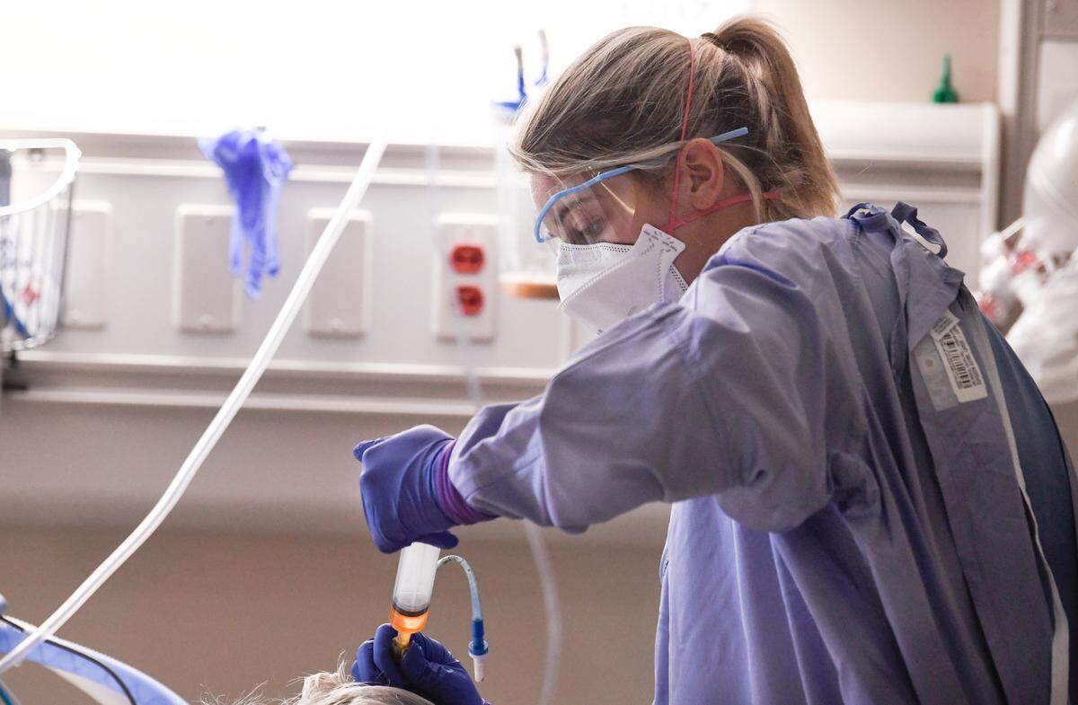 Katie Downey, RN, cares for a COVID patient in the Medical Intensive Care Unit at UNC Hospital in Chapel Hill, N.C. Wednesday, Aug. 11, 2021.