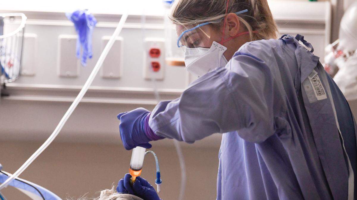 Registered nurse Katie Downey cares for a COVID-19 patient in the Medical Intensive Care Unit at UNC Medical Center in Chapel Hill, N.C., on Aug. 11, 2021.