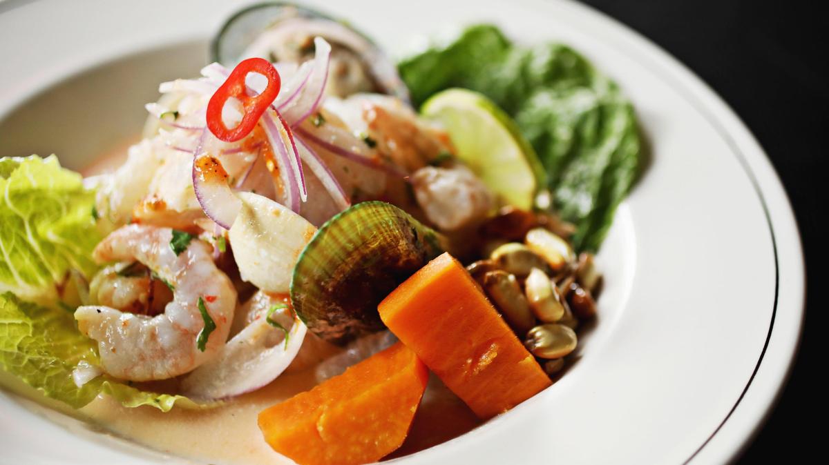 The house specialty ceviche at Pisco Mar is a bountiful catch of fish and shellfish, tossed in the classic Peruvian dressing of lime juice and rocoto pepper and spangled with cilantro, red onion and served with the traditional accompaniments of sweet potato and crunchy kernels of corn called cancha.