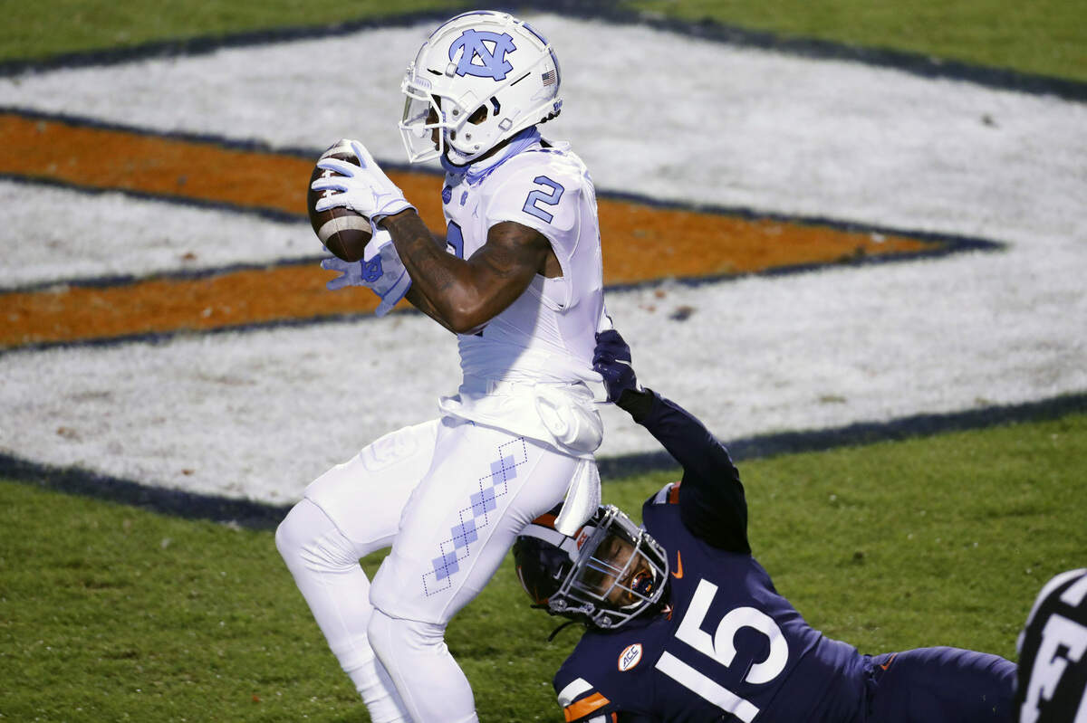 UNC’s Dyami Brown (2) scores in first half action as Virginia’s De’Vante Cross defends Saturday night, Oct. 31, 2020.