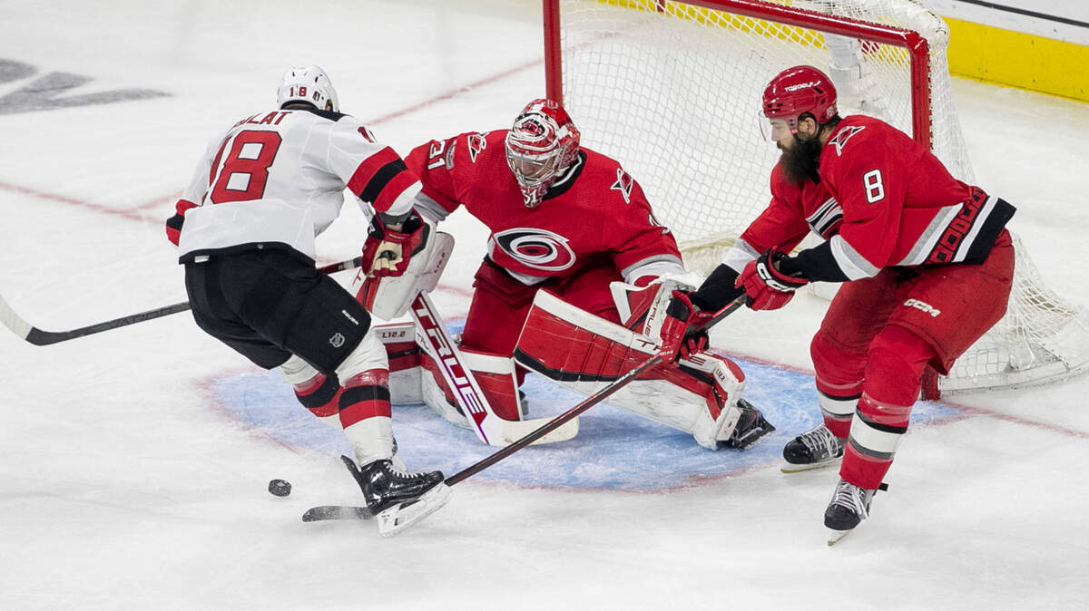 The Carolina Hurricanes Brent Burns (8) stops a scoring attempt on goalie Carolina Hurricanes goalie Frederik Andersen (31) by the New Jersey Devils Ondrej Palat (18) in the third period during Game 5 of their second round Stanley Cup playoff series on Thursday, May 11, 2023 at PNC Arena in Raleigh, N.C.
