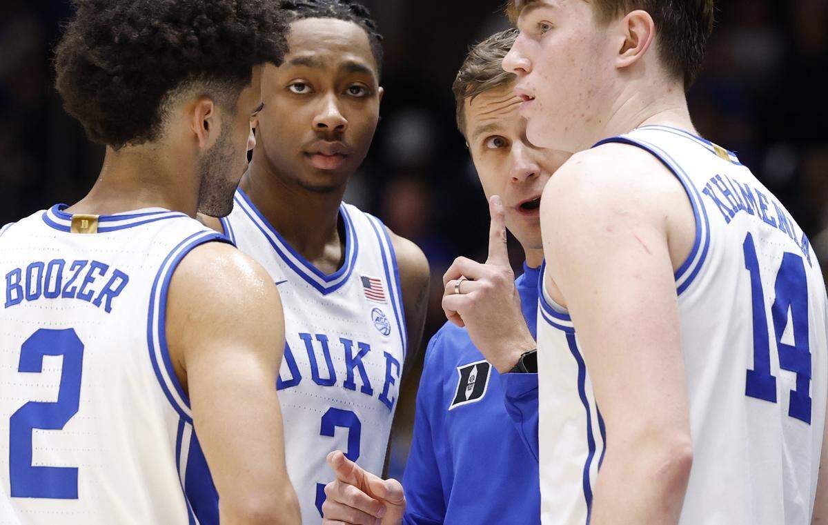 Duke head coach Jon Scheyer talks to Cayden Boozer (2), Isaiah Evans (3) and Nikolas Khamenia (14) during the second half of Duke’s 90-69 victory over Wake Forest at Cameron Indoor Stadium in Durham, N.C., Saturday, Jan. 24, 2026.