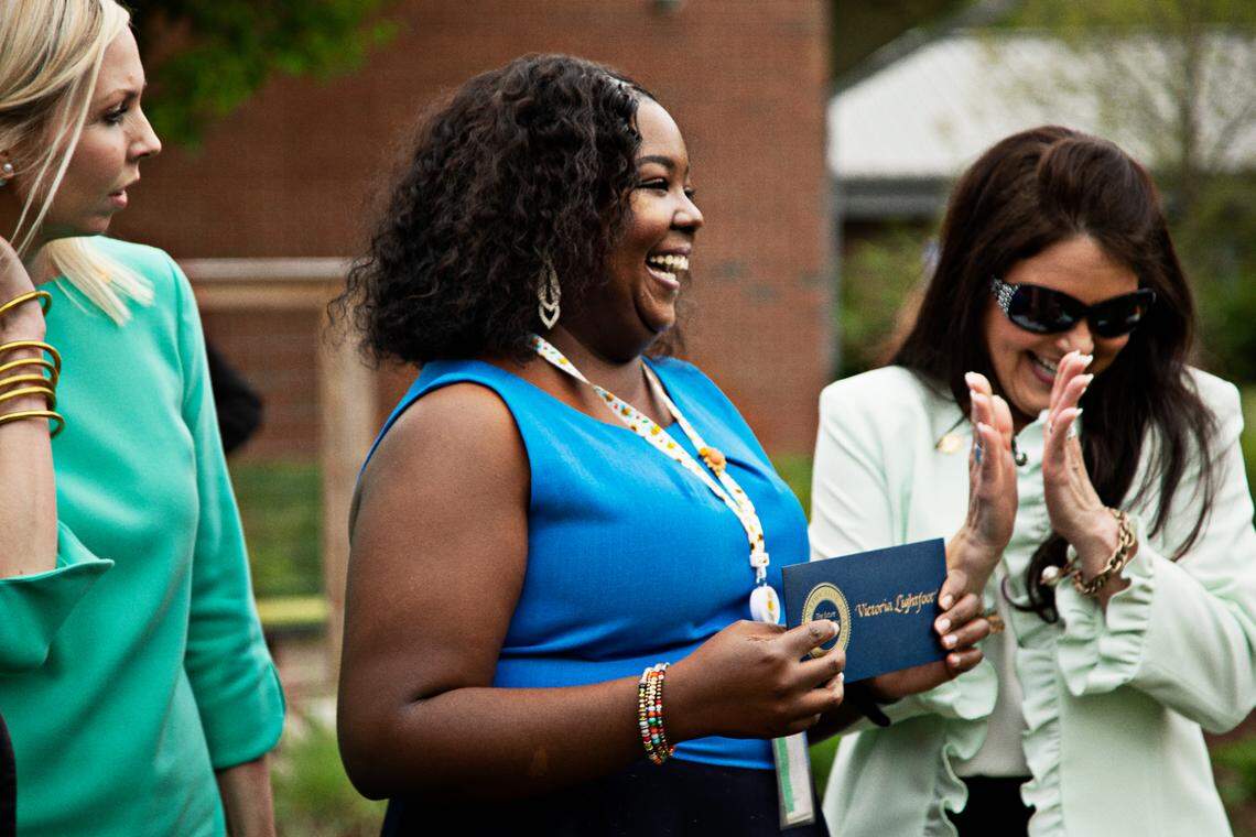 Victoria Lightfoot, center, of MIllbrook Elementary School in Raleigh is congratulated on Friday, May 5, 2022, after winning the Milken Educator Award, a prize sometimes called the ‘Oscars of Teaching’ that includes a $25,000 prize.