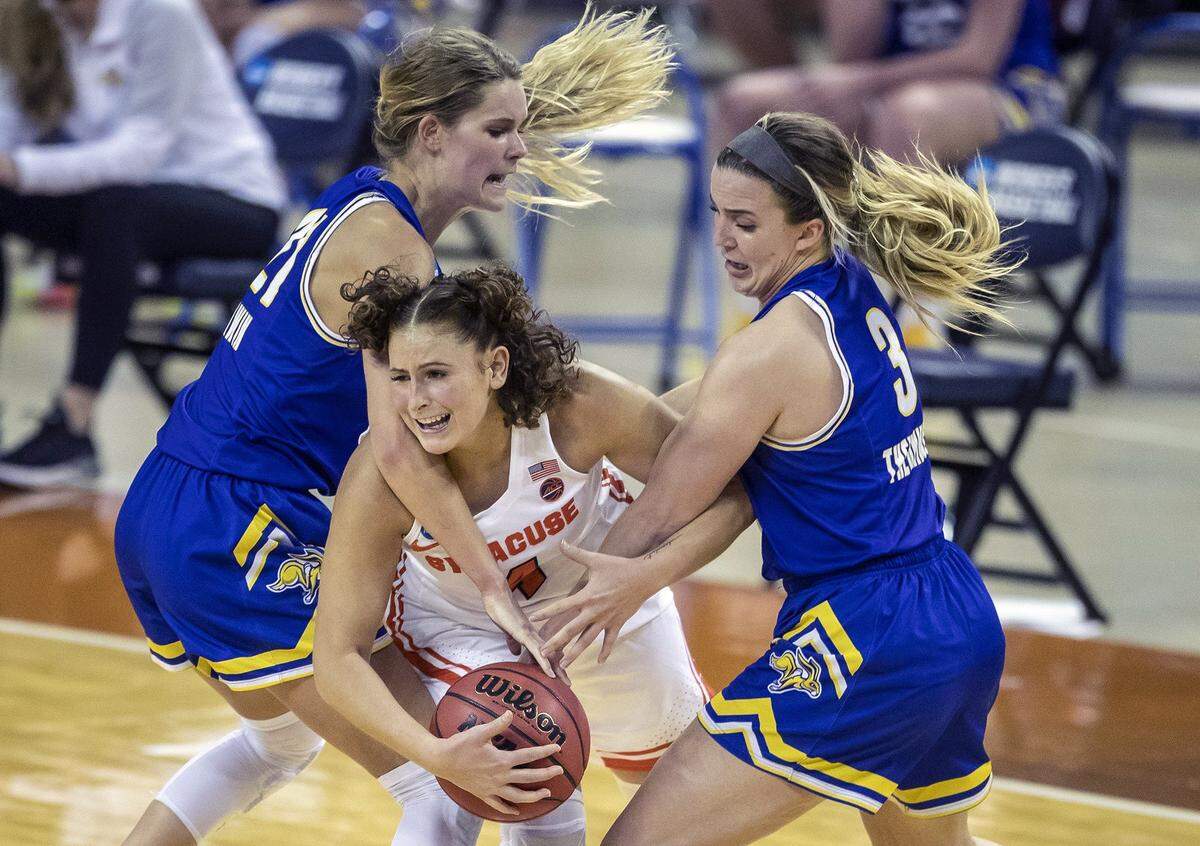 Syracuse guard Tiana Mangakahia (4) is fouled by South Dakota State guard Lindsey Theuninck (3) and South Dakota State guard Tylee Irwin (21) during the second half of a college basketball game in the first round of the women’s NCAA tournament at the Frank Erwin Center in Austin, Texas, Sunday, March 21, 2021. 