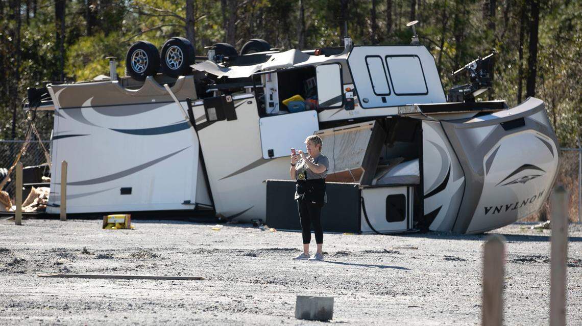 Jean Jensen stands beside her RV which was destroyed by a tornado at the Ocean Ridge Storage Solutions on Seaside Road in Sunset Beach, N.C. on Tuesday, February 16, 2021 after a tornado ripped through the Brunswick County community late Monday night. Jensen and her husband has just purchased the RV and had never used it.