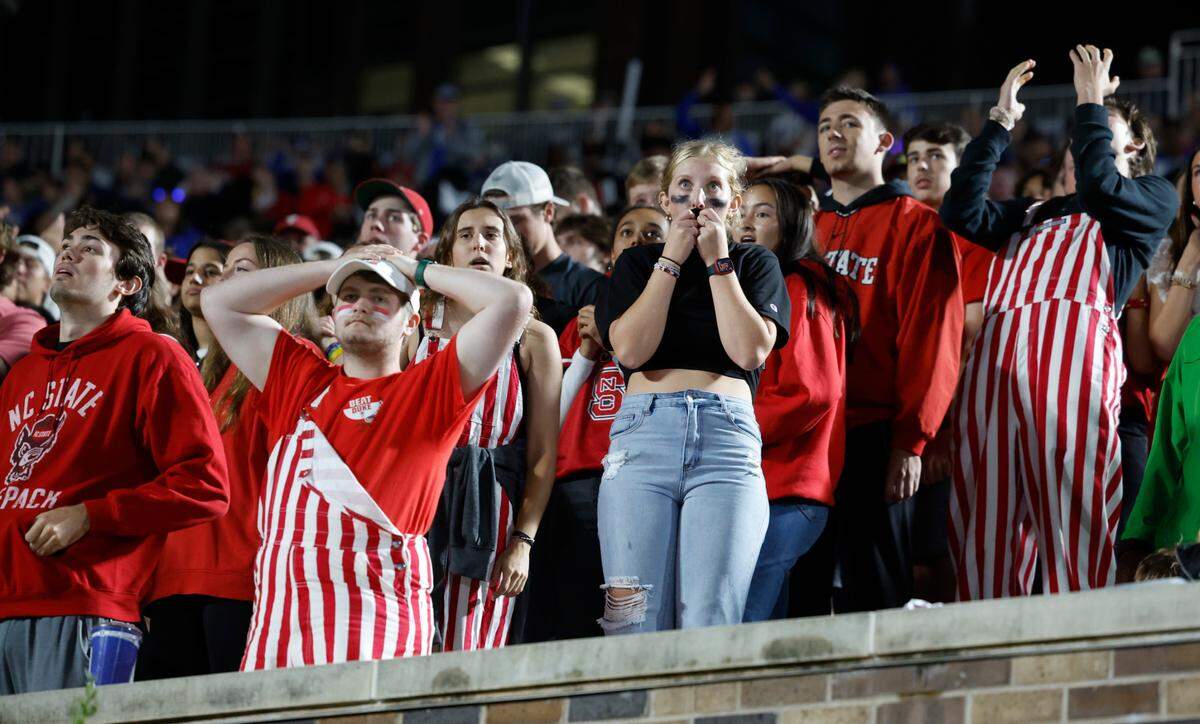 N.C. State fans react to a play during the first half of the Wolfpack’s game against Duke at Wallace Wade Stadium in Durham, N.C., Saturday, Oct. 14, 2023.