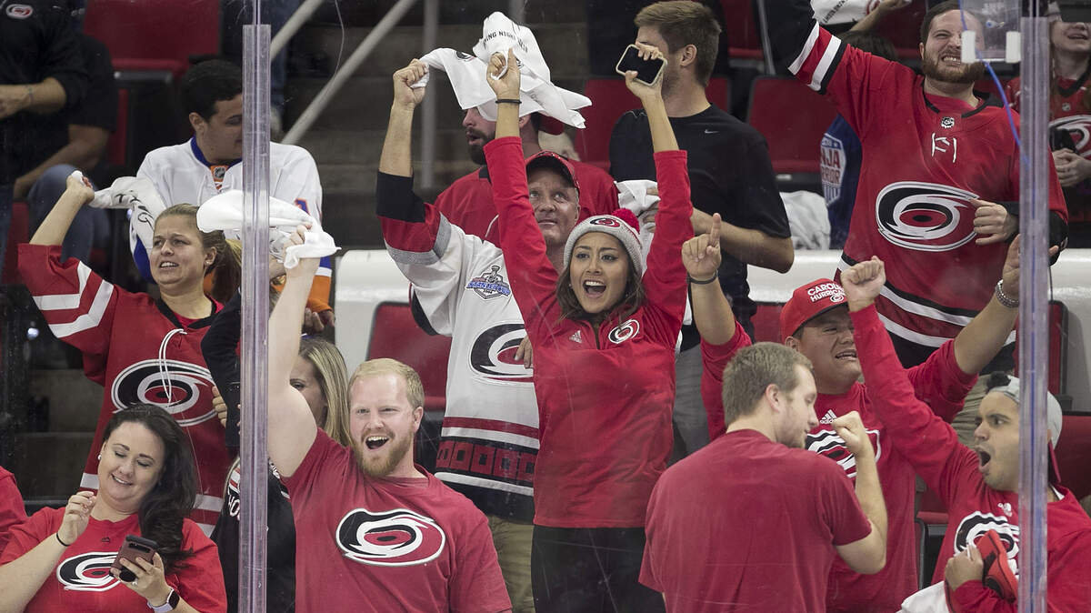 Carolina Hurricanes fans celebrates after Jordan Staal’s goal in the third period was reviewed and approved during their home opener against the New York Islanders on Thursday, October 4, 2018 at PNC Arena in Raleigh, N.C.