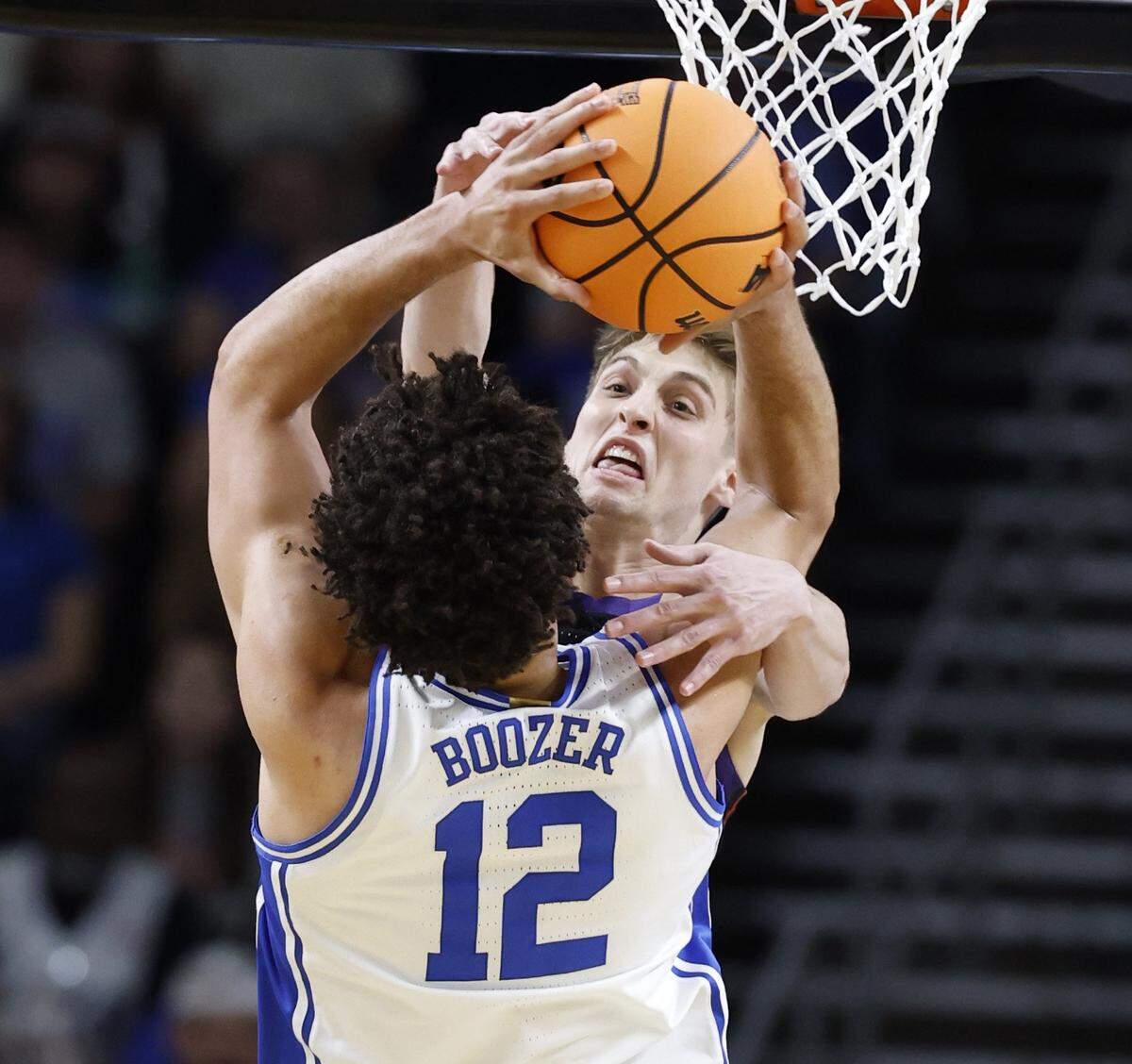 TCU’s Tanner Toolson (55) alters the shot by Duke’s Cameron Boozer (12) during the first half of Duke’s game against TCU in the second round of the NCAA Men’s Basketball Tournament at  Bon Secours Wellness Arena in Greenville, S.C., Saturday, March 21, 2026.