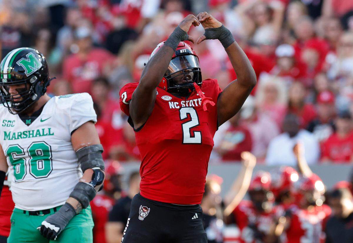 N.C. State linebacker Jaylon Scott (2) celebrates after sacking Marshall quarterback Cam Fancher during the second half of N.C. State’s 48-41 victory over Marshall at Carter-Finley Stadium in Raleigh, N.C., Saturday, Oct. 7, 2023.