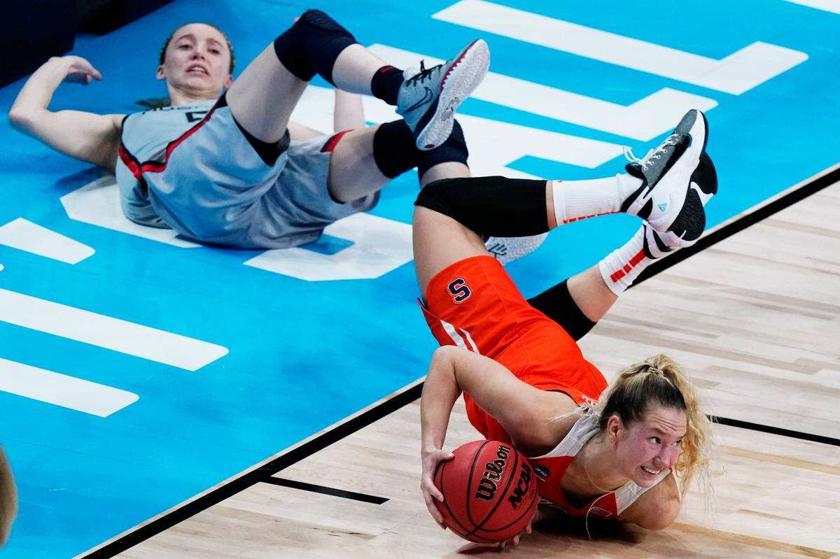 Syracuse forward Digna Strautmane, front, looks to pass the ball after UConn guard Paige Bueckers, back, attempted to steal during the first half of a college basketball game in the second round of the women’s NCAA tournament at the Alamodome in San Antonio, Tuesday, March 23, 2021. 