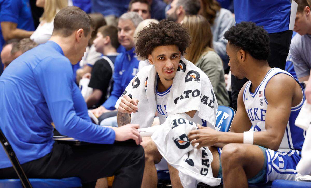 Duke’s Tyrese Proctor (5) talks with Jeremy Roach (3) and head coach Jon Scheyer before the start of the second half of Duke’s 80-65 victory over Boston College at Cameron Indoor Stadium in Durham, N.C., Saturday, Feb. 10, 2024.