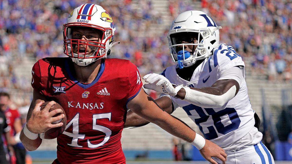 Kansas tight end Trevor Kardell (45) is chased by Duke defensive back Joshua Pickett (26) as he runs for a touchdown during the first half of an NCAA college football game Saturday, Sept. 24, 2022, in Lawrence, Kan. (AP Photo/Charlie Riedel)