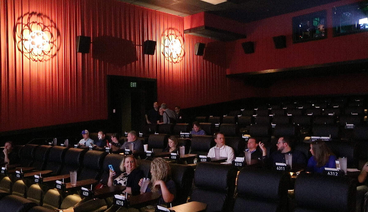 Invited guests for a sneak preview wait for the presentation to start in one of the 11 theaters at the Alamo Draft House Raleigh.