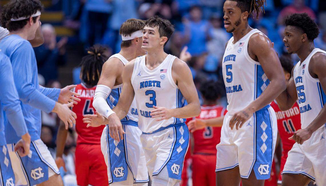 North Carolina’s Cormac Ryan (3) is greeted by teammates after sinking a three-point basket to give the Tar Heels a 74-61 lead in the second half against Radford on Monday, November 6, 2023 at the Dean Smith Center in Chapel Hill, N.C.