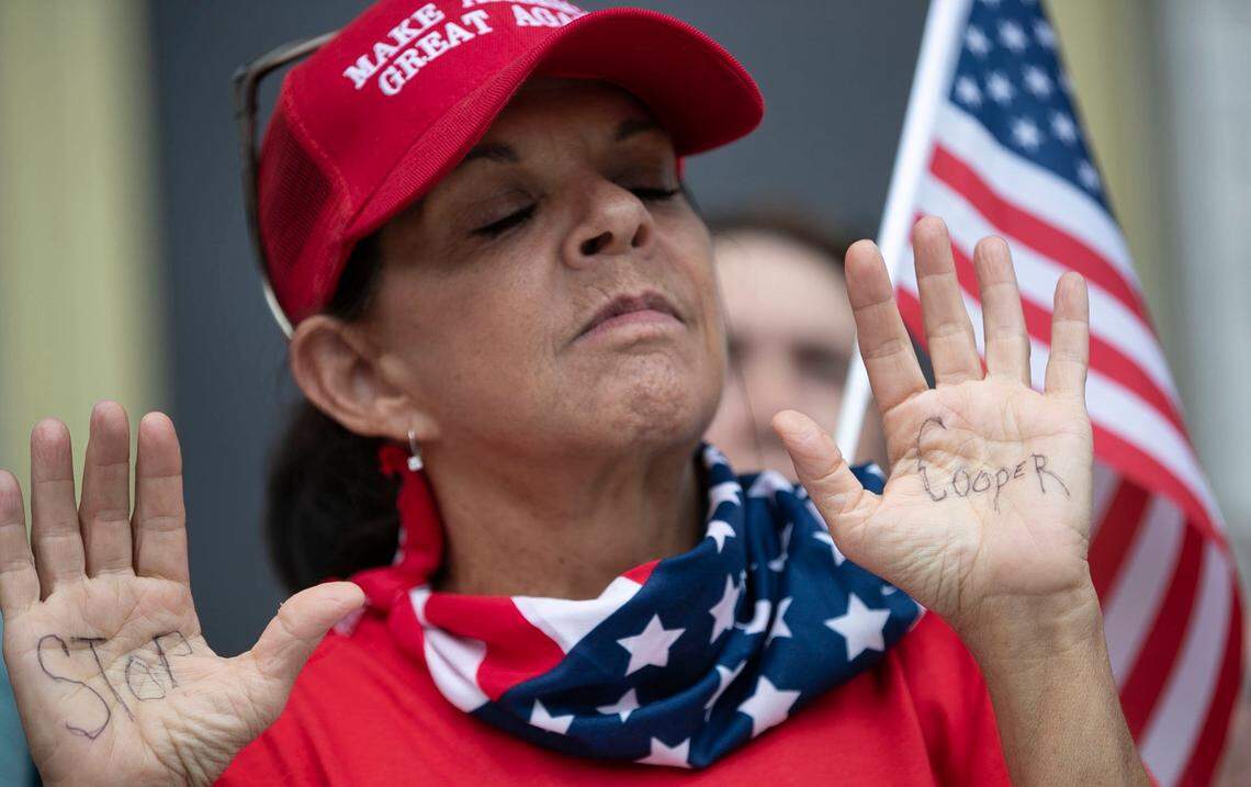 Protesters from ReopenNC rally at the General Assembly to lobby lawmakers to begin impeachment proceedings against North Carolina Governor Roy Cooper for his handling of the coronavirus restrictions that have closed many businesses on Wednesday, July 8, 2020 in Raleigh, N.C.