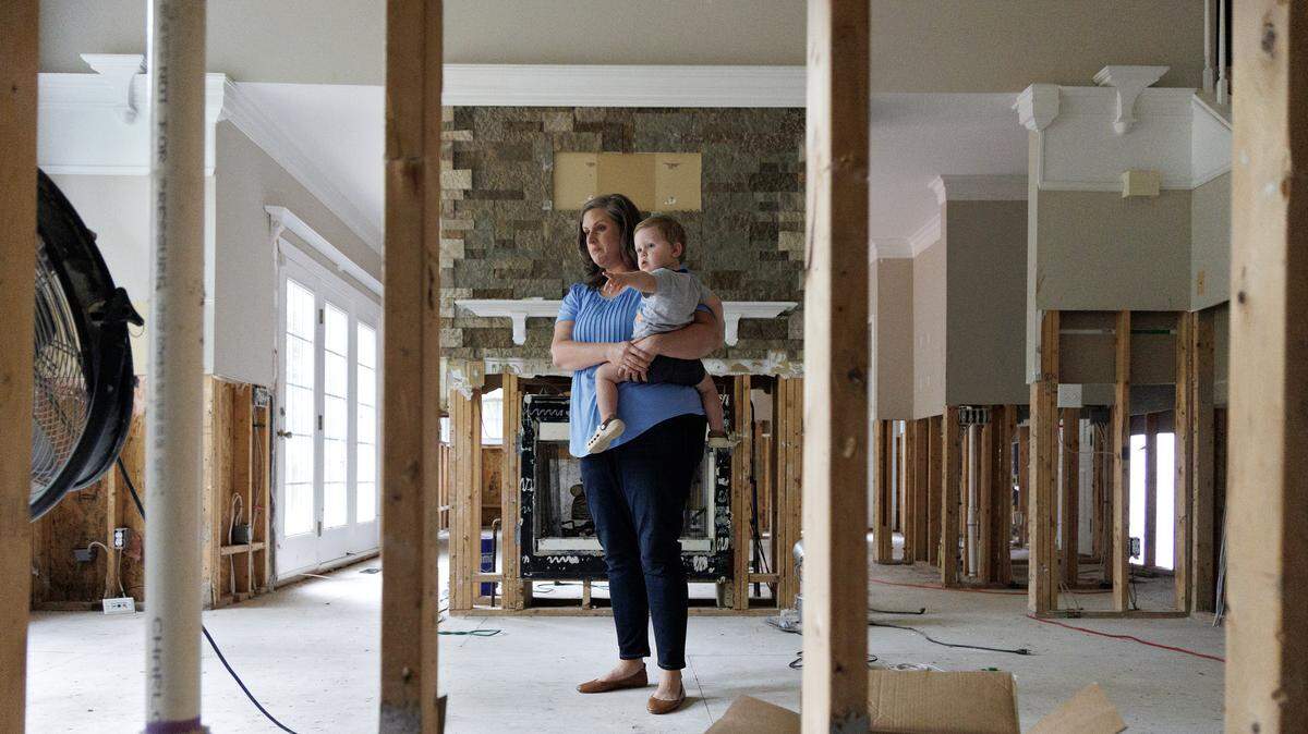Rebecca Blough holds her 1-year-old son, Henry, on Friday, Sept. 26, 2025, in her Pittsboro home, which was severely damaged by flooding from Tropical Storm Chantal. Blough and her husband had flood insurance, but not enough to cover all of the damage from the storm, which destroyed their home’s foundation.