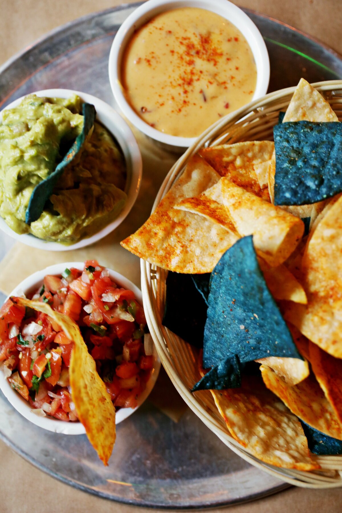 You wonâ€™t go wrong with Tamale Factory and Tequila Bar’s sampler trio of fresh guacamole, pico de gallo and queso blanco dip, served with warm, spice-dusted blue and white tortilla chips.