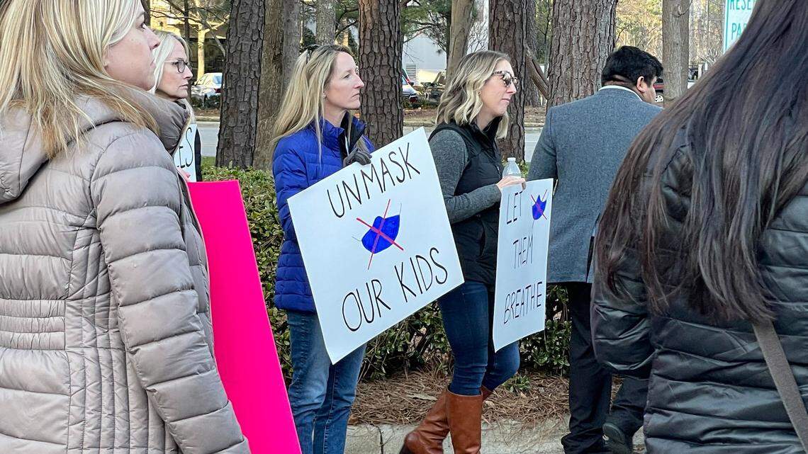 A crowd rallies outside the Wake County school board meeting in Cary Tuesday, Feb. 15, 2022, demanding that the district immediately stop mandating that students wear masks.