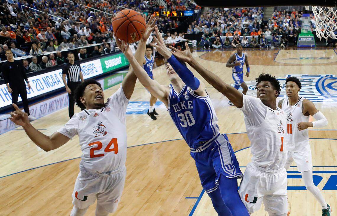 Duke’s Kyle Filipowski (30) battles for a rebound with Miami’s Nijel Pack (24) and Anthony Walker (1) during Duke’s 85-78 victory over Miami in the semifinals of the ACC Men’s Basketball Tournament in Greensboro, N.C., Friday, March 10, 2023.