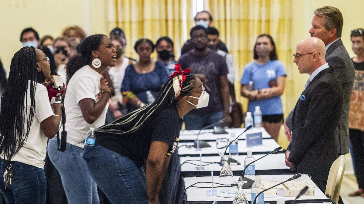 Demonstrators confront Gene Davis, vice chairman of the UNC-Chapel Hill Board of Trustees, and Chancellor Kevin Guskiewicz after a controversial vote on tenure for distinguished journalist Nikole Hannah-Jones in June 2021.