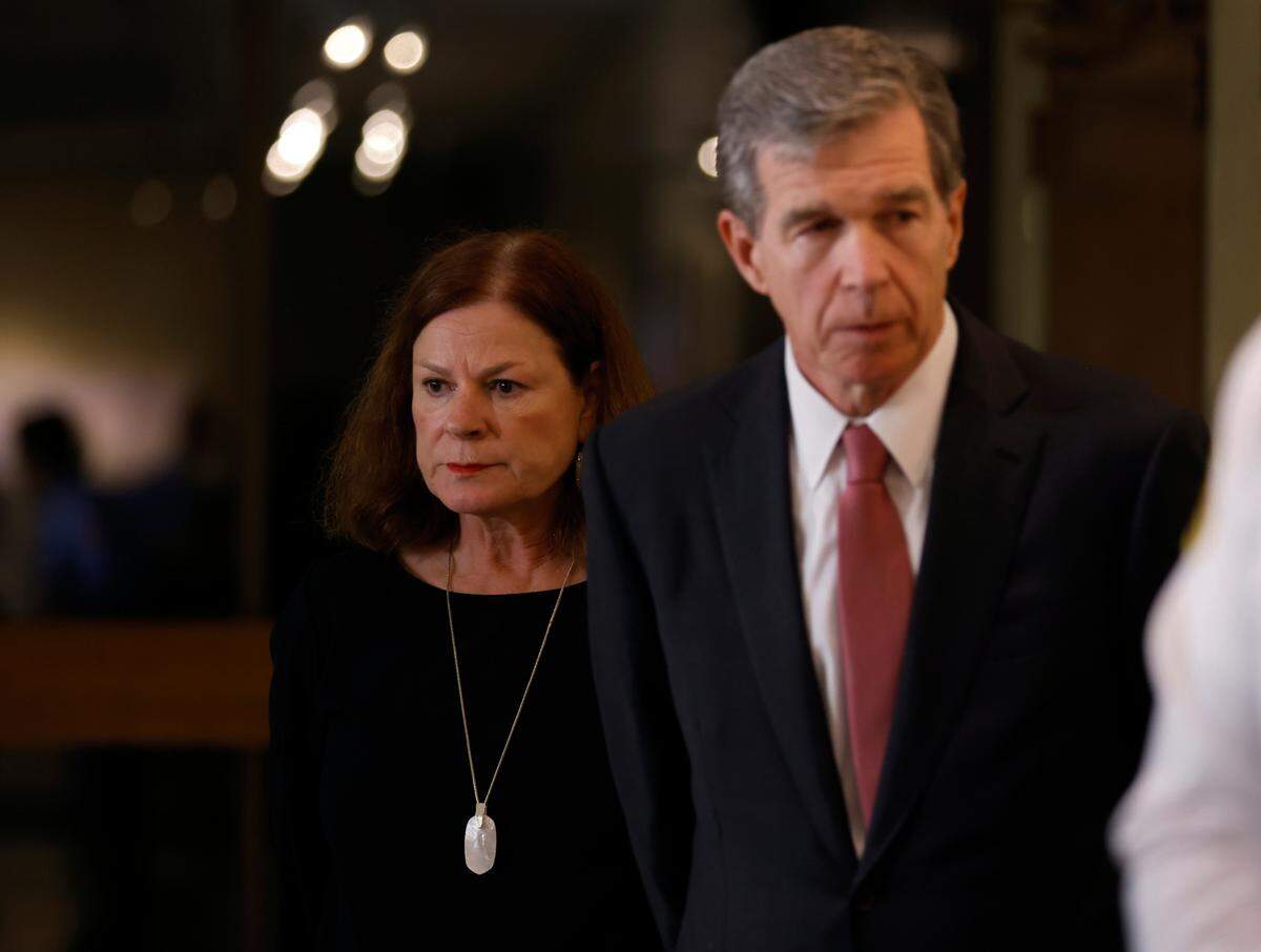 Raleigh Mayor Mary-Ann Baldwin and North Carolina Gov. Roy Cooper listen during a press briefing about a shooting that left five people dead, including an off-duty police officer, on Thursday, Oct. 13, 2022, in Raleigh, N.C.