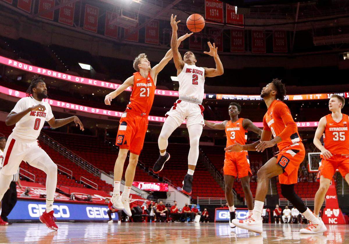 Syracuse’s Marek Dolezaj (21) knocks the ball from the hands of N.C. State’s Shakeel Moore (2) during Syracuse’s 77-68 victory over N.C. State at PNC Arena in Raleigh, N.C., Tuesday, February 9, 2021.