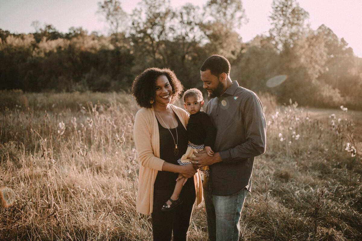 Tiffany Griffin and her husband, Dariel Heron, started making candles as a hobby. They founded Bright Black Candles last year. Here they are pictured with their daughter, Elena.