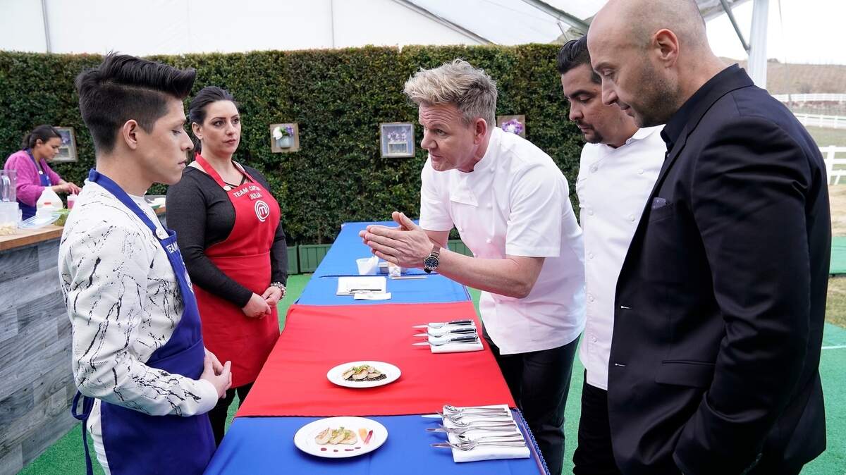 Contestants Juni Cuevas (left) and Julia Danno listen to critiques from judges Gordon Ramsay (left), Aarón Sánchez (center) and Joe Bastianich in the July 11 episode of "MasterChef" on Fox.