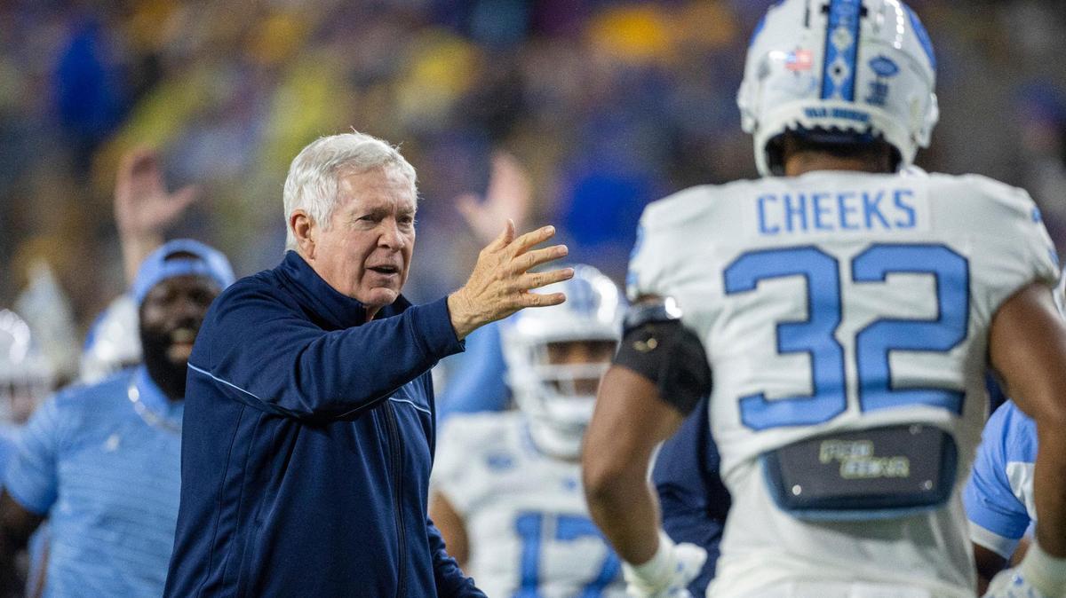 North Carolina coach Mack Brown congratulates his players after a 52-yards punt return by Alijah Huzzie (28) to give the Tar Heels a 21-14 lead over Pitt in the second quarter on Saturday, September 23, 2023 at Acrisure Stadium in Pittsburgh, Pa.