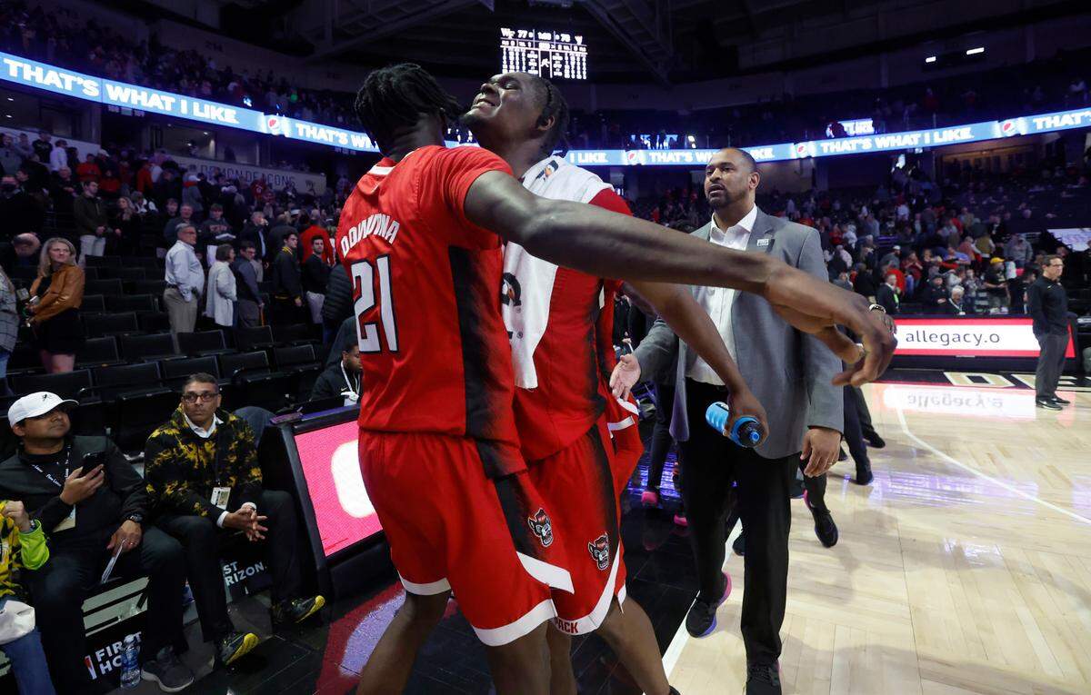 N.C. State’s D.J. Burns Jr. (30) celebrates with Ebenezer Dowuona (21) after N.C. State’s 79-77 victory over Wake Forest at Joel Coliseum in Winston-Salem, N.C., Saturday, Jan. 28, 2023.