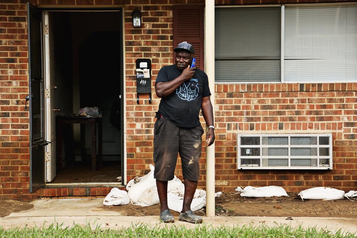 Howard West talks on the phone as he waits for a crew near his flooded apartment at Camelot Village Condominiums off of Estes Drive in Chapel Hill on Tuesday, Sept. 18, 2018.  West, who has lived in the apartment for three years, was upstairs at a neighbor’s apartment when it flooded.