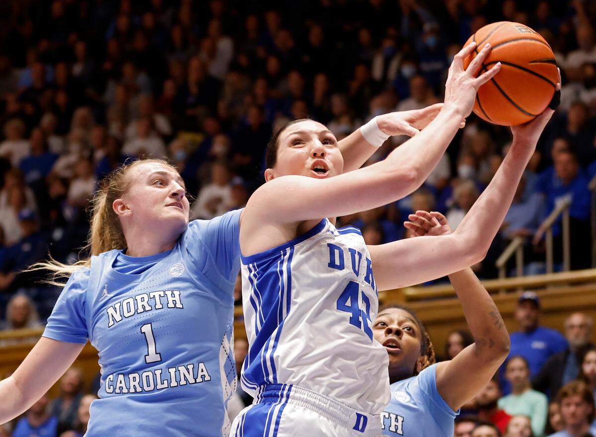 Duke’s Mia Heide pulls down a rebound in front of North Carolina’s Alyssa Ustby and Kayla McPherson during the first half of North Carolina’s 45-41 win over Duke on Sunday, Feb. 26, 2023, at Cameron Indoor Stadium in Durham, N.C.