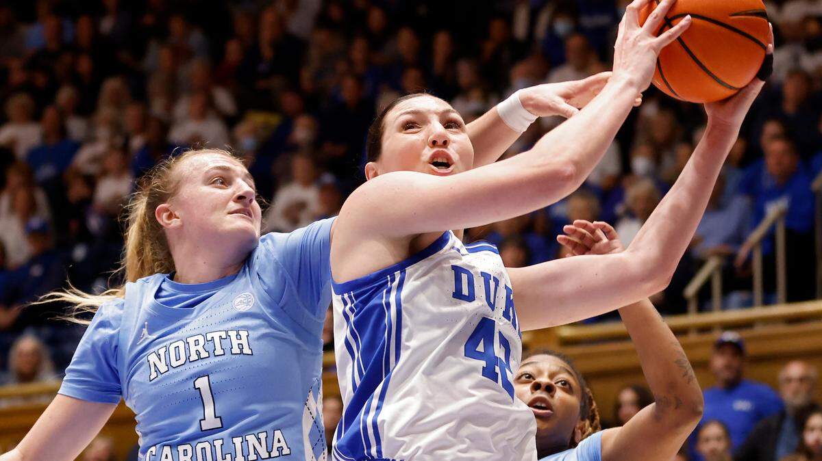 Duke’s Mia Heide pulls down a rebound in front of North Carolina’s Alyssa Ustby and Kayla McPherson during the first half of North Carolina’s 45-41 win over Duke on Sunday, Feb. 26, 2023, at Cameron Indoor Stadium in Durham, N.C.