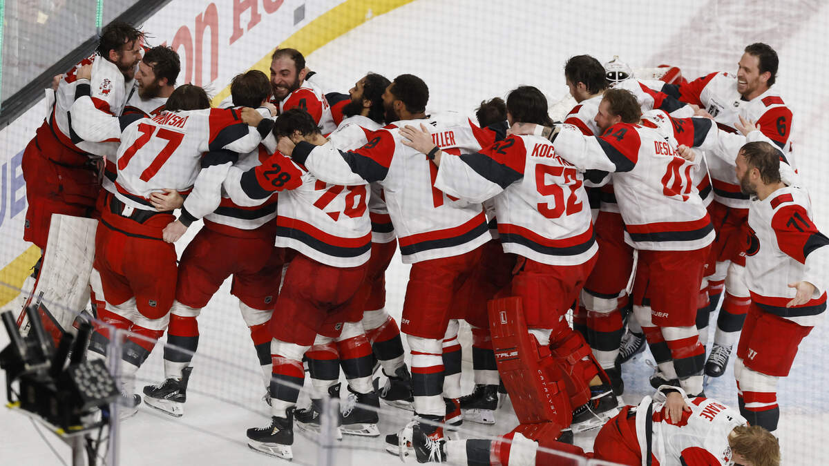 The Carolina Hurricanes celebrate on the ice after defeating Vegas to win the Stanley Cup Championship.