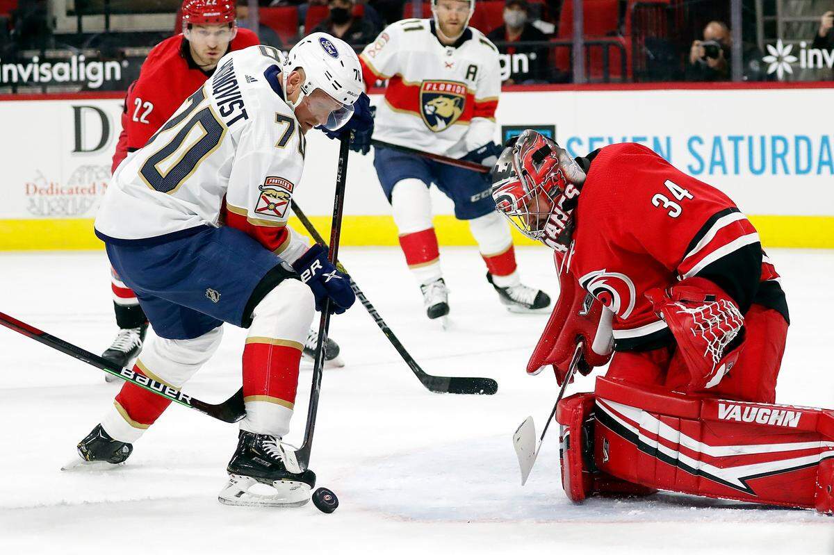 Florida Panthers’ Patric Hornqvist (70) tries to control the puck in front of Carolina Hurricanes goaltender Petr Mrazek (34) during the first period of an NHL hockey game in Raleigh, N.C., Tuesday, April 6, 2021. (AP Photo/Karl B DeBlaker)