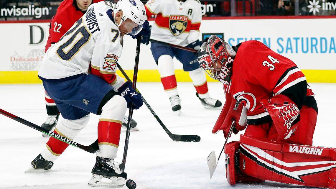 Florida Panthers’ Patric Hornqvist (70) tries to control the puck in front of Carolina Hurricanes goaltender Petr Mrazek (34) during the first period of an NHL hockey game in Raleigh, N.C., Tuesday, April 6, 2021. (AP Photo/Karl B DeBlaker)