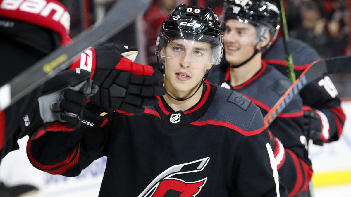 Carolina Hurricanes’ Teuvo Teravainen (86) of Finland celebrates with teammates as he comes back to the bench after he scored during the second period of an NHL hockey game in Raleigh, N.C. Friday, Oct. 26, 2018.