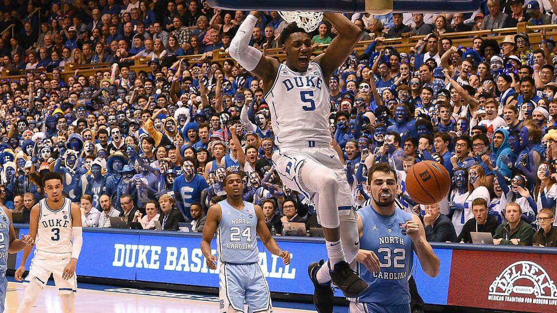 Duke forward RJ Barrett (5) slams home a dunk over UNC forward Luke Maye (32) in the first half. UNC defeated Duke 88-72 at Cameron Indoor Stadium In Durham, N.C., Wed., Feb.20, 2019.