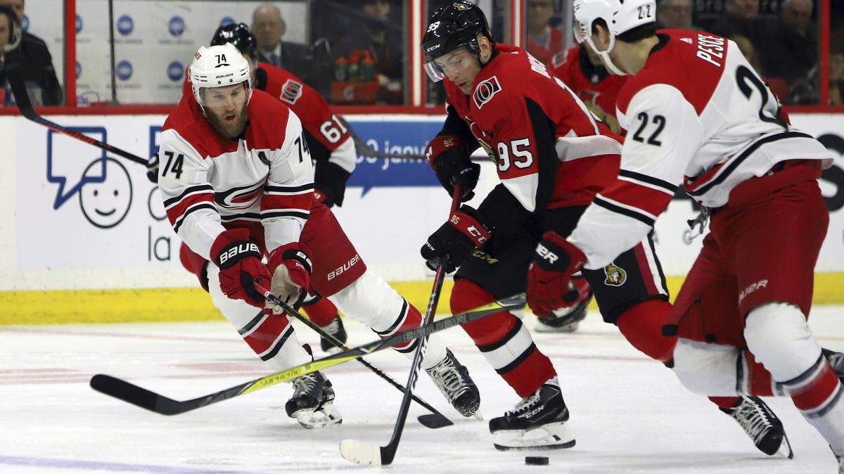 Ottawa Senators’ Matt Duchene (95) moves the puck against Carolina Hurricanes’ Jaccob Slavin (74) and Brett Pesce (22) during first-period NHL hockey play in Ottawa, Ontario, Sunday, Jan. 6, 2019. (Fred Chartrand/The Canadian Press via AP)